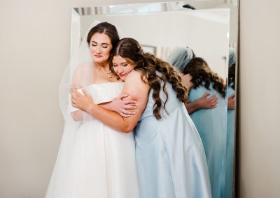 bride hugging bridesmaid