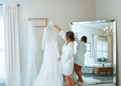 bride admiring wedding dress