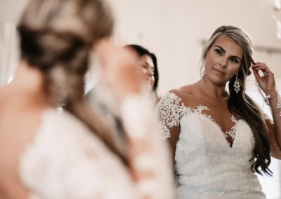 Bride looking at mirror in Bridal Suite at The Julianna